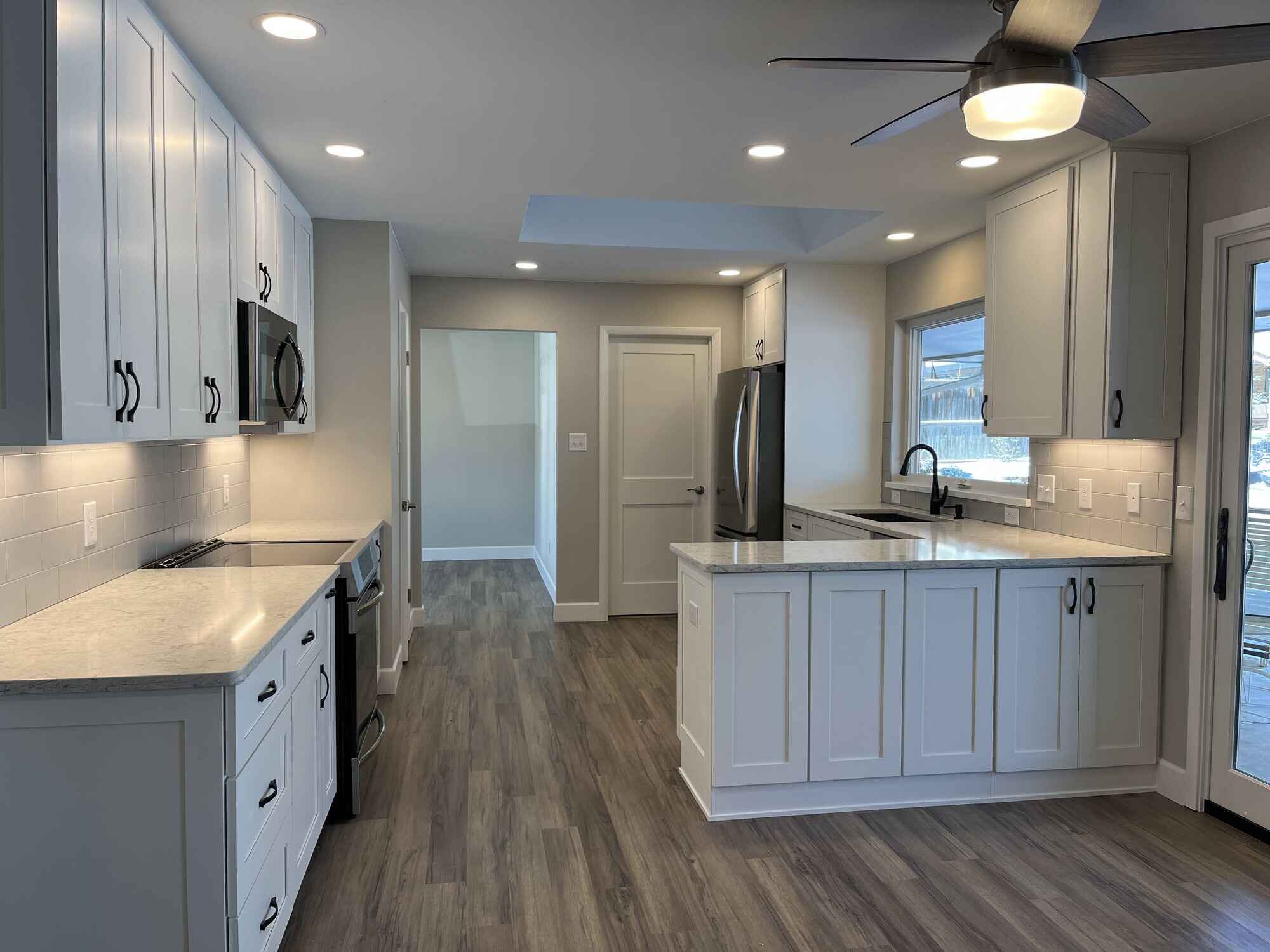 Custom-bright-kitchen-white-cabinets-vinyl-floors-Littleton-Colorado angled by Grimes Home Concepts