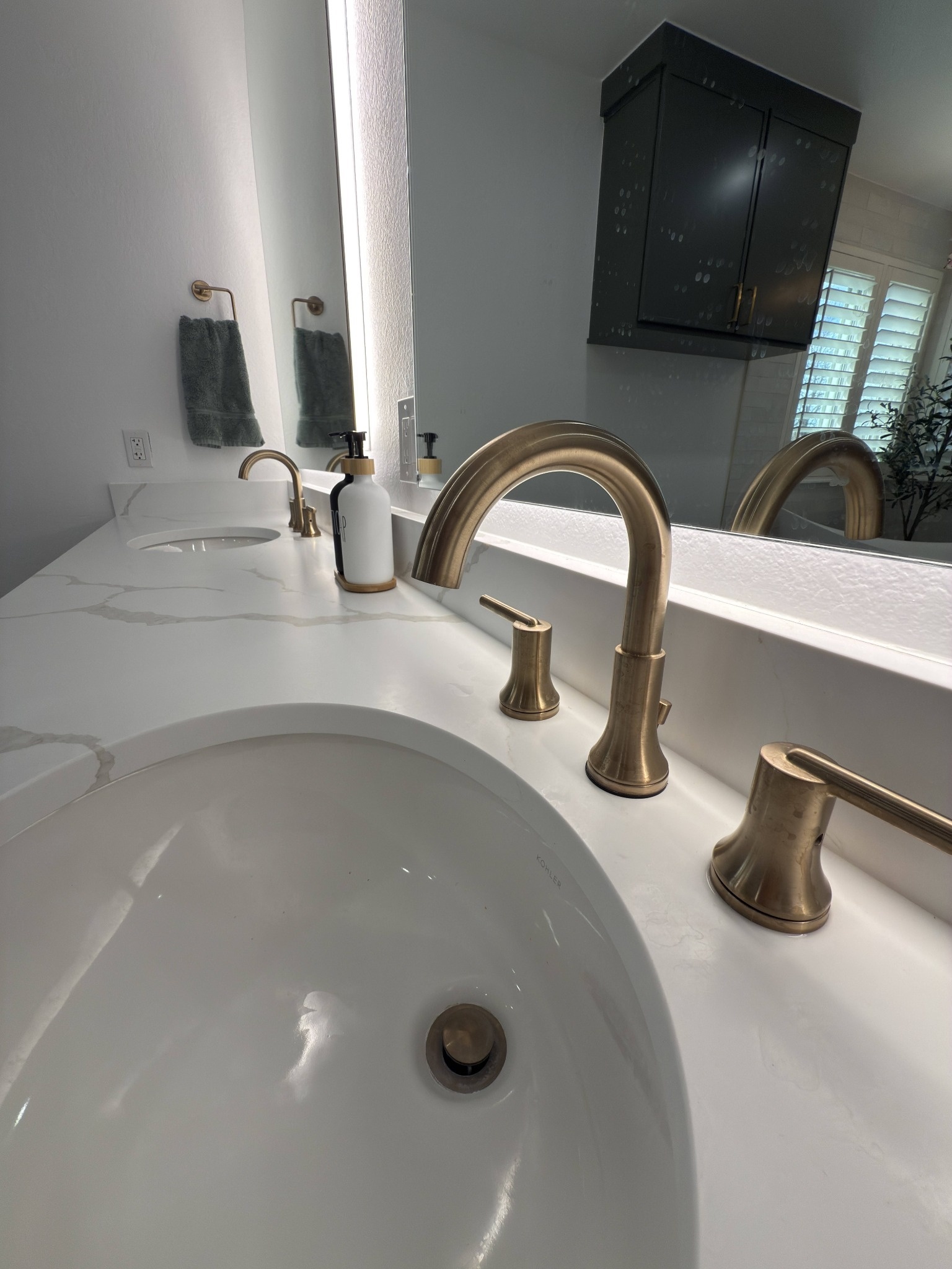 after littleton bathroom remodel brushed brass faucet on white quartz vanity