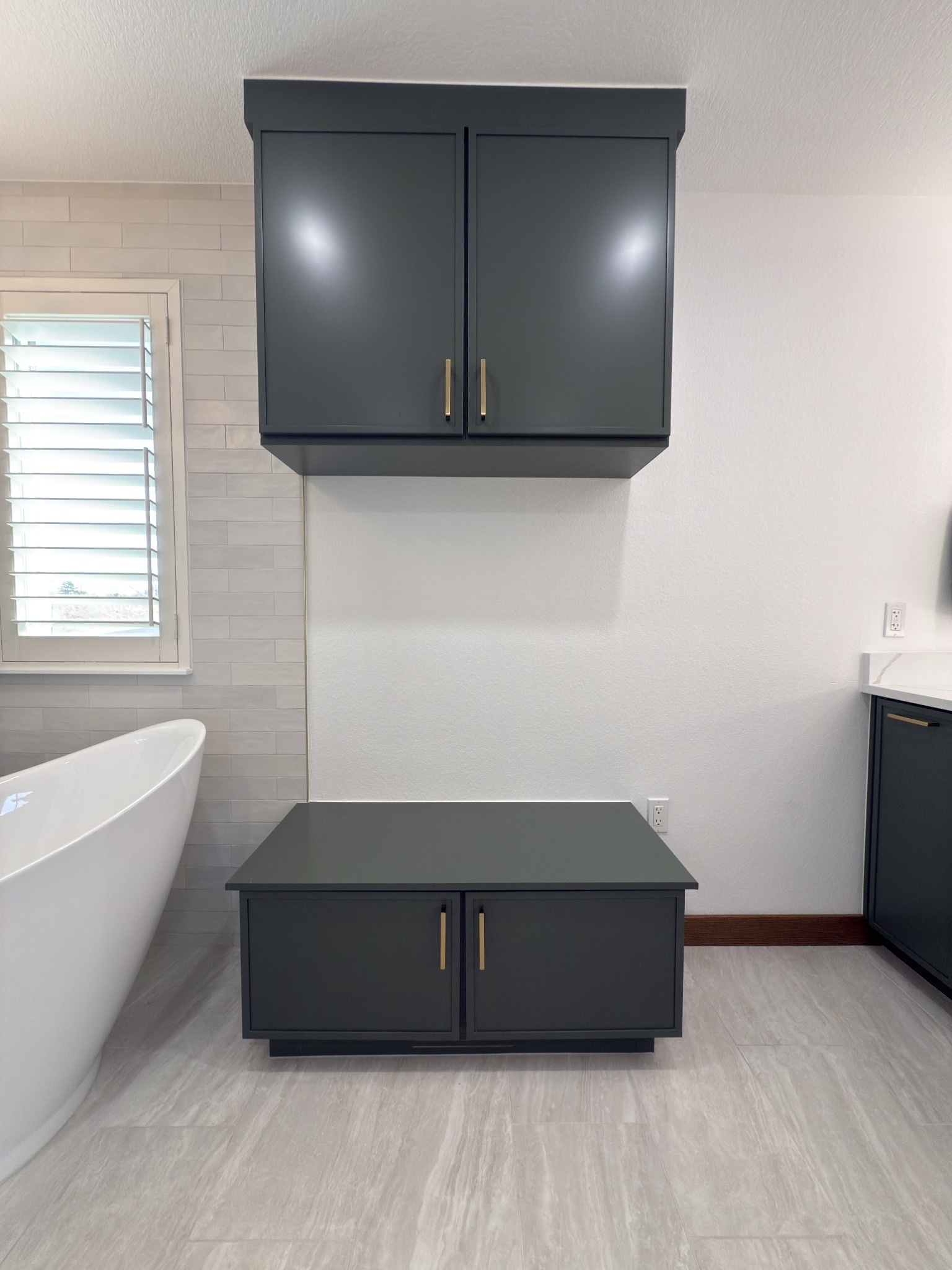 after littleton bathroom remodel dark linen cabinets beside freestanding tub