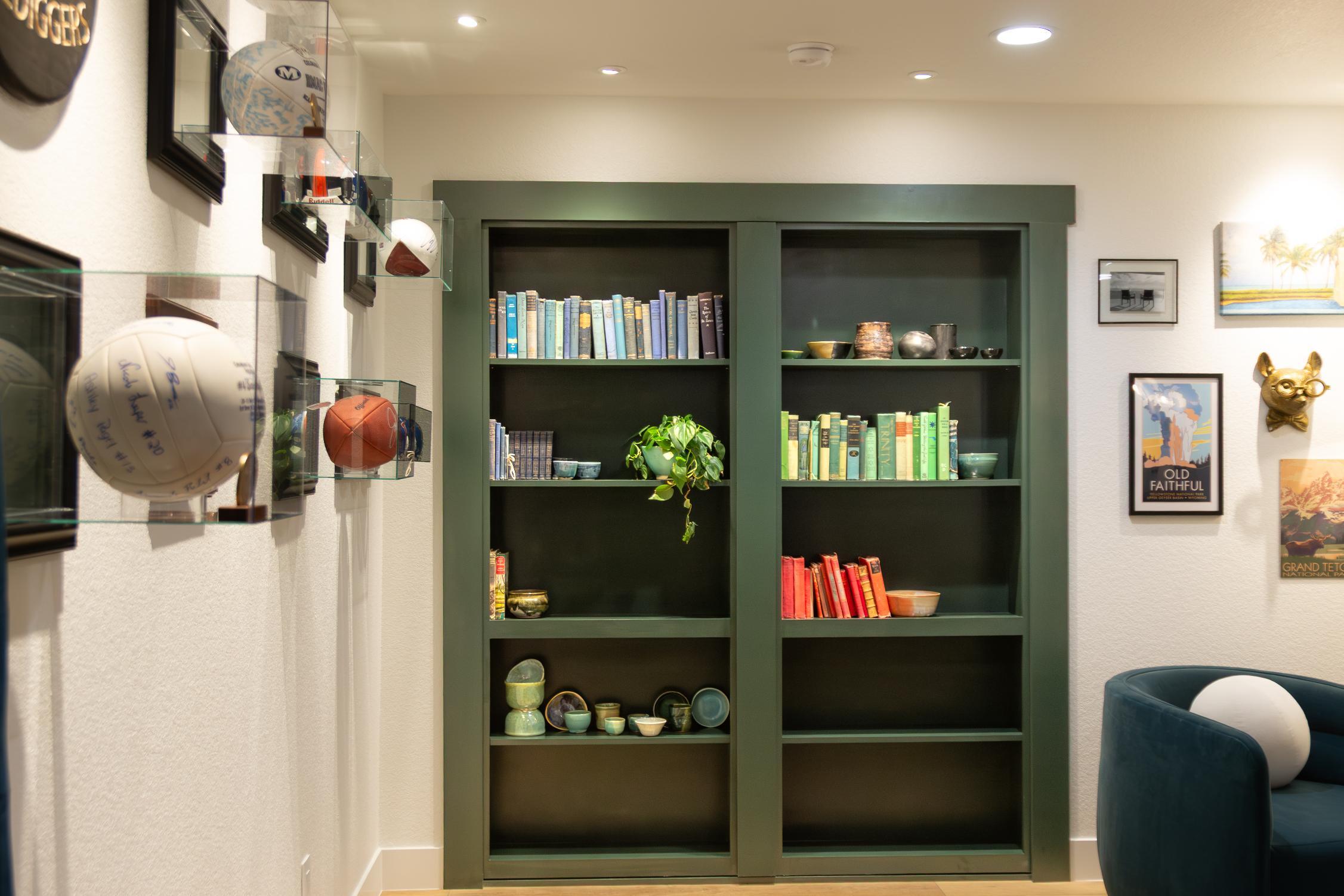 Corner view of built in green bookshelf in Denver by Grimes Home Concepts