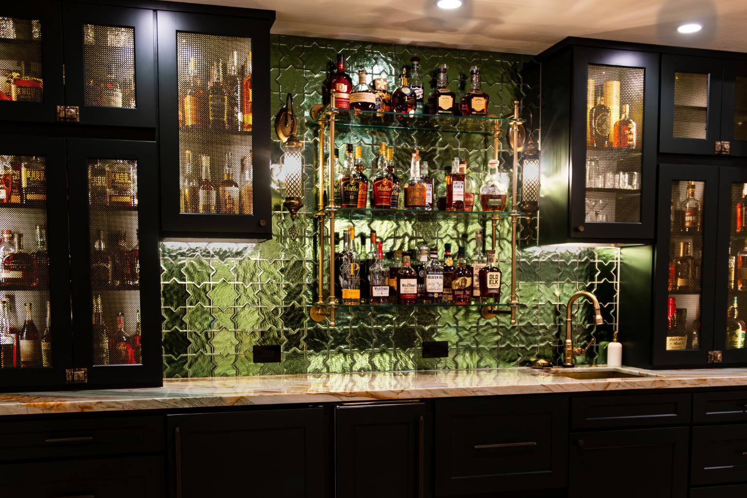 Front on view of black custom cabinetry and green tile in basement bar in basement remodel in Denver by Grimes Home Concepts