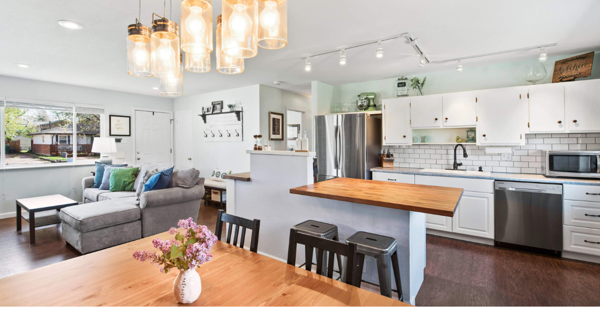 kitchen remodel with island bar, beautiful lighting, & an open concept.